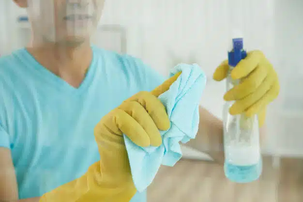Spraying window with cleaning liquid wiping with cloth