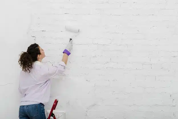 Woman painting wall