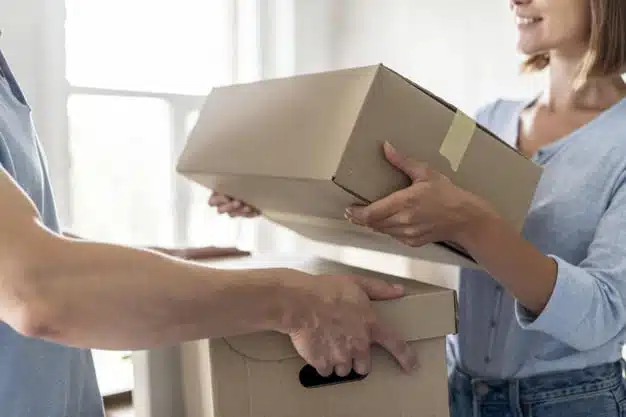 Couple with boxes moving out