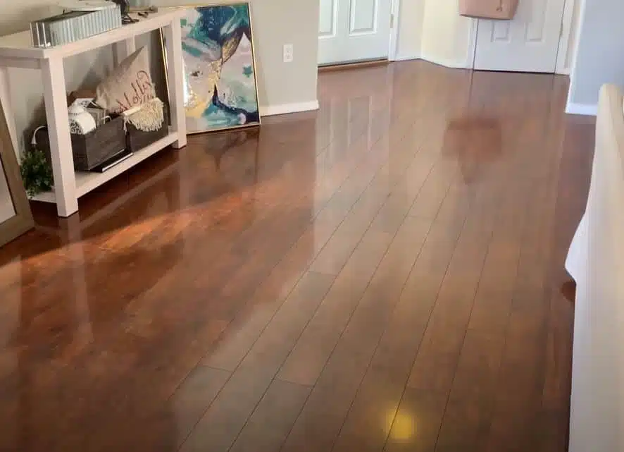 a man cleaning laminate flooring with a swivel mop