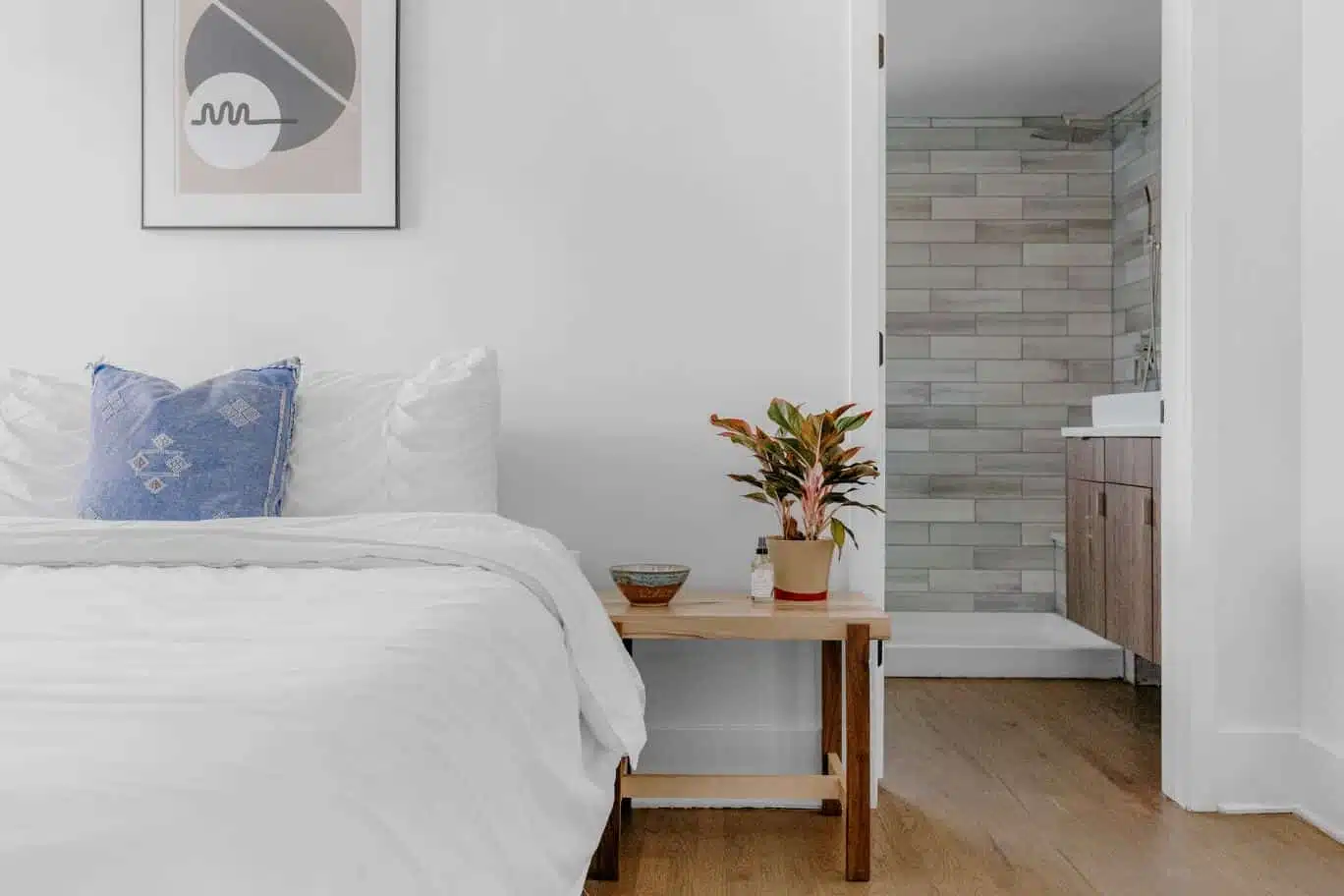 Queen size bed with white sheets and a blue pillow.