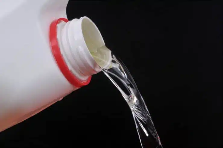 white bottle of bleach being poured out