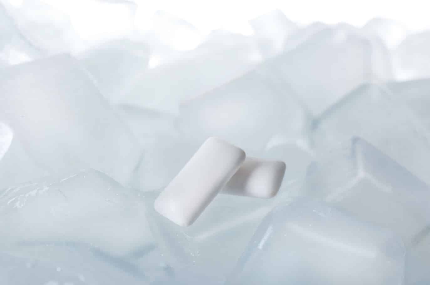 two chewing gum tablets on ice cubes