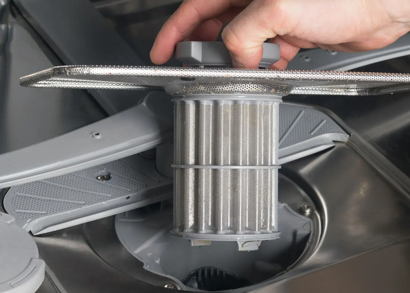 close up of man holding dishwasher mesh
