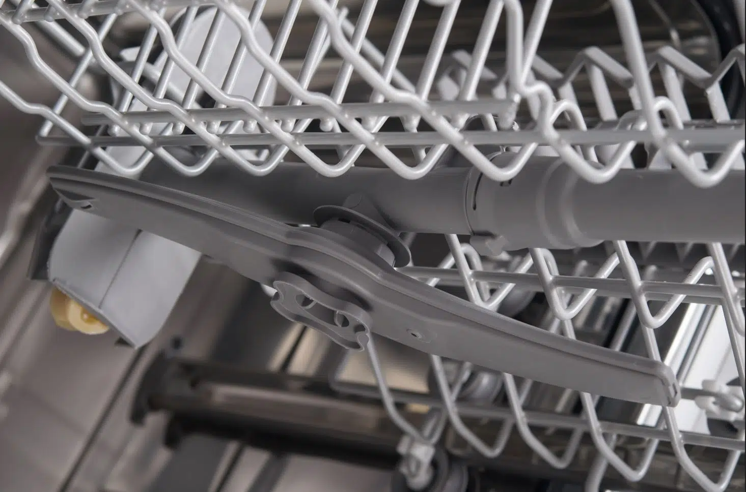close up of the inside of a broken dishwasher