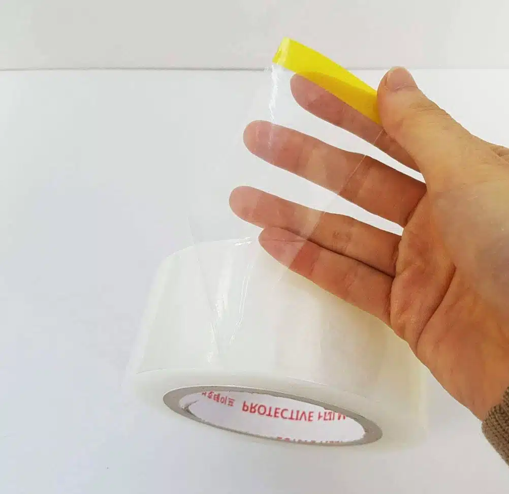 close up of man holding wide packaging tape