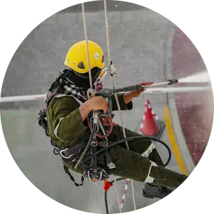 MaidForYou pressure washer Jun cleaning the outside windows of a high rise building