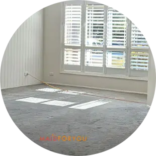 Large emprty light filled living room with shutters open after being c leaned